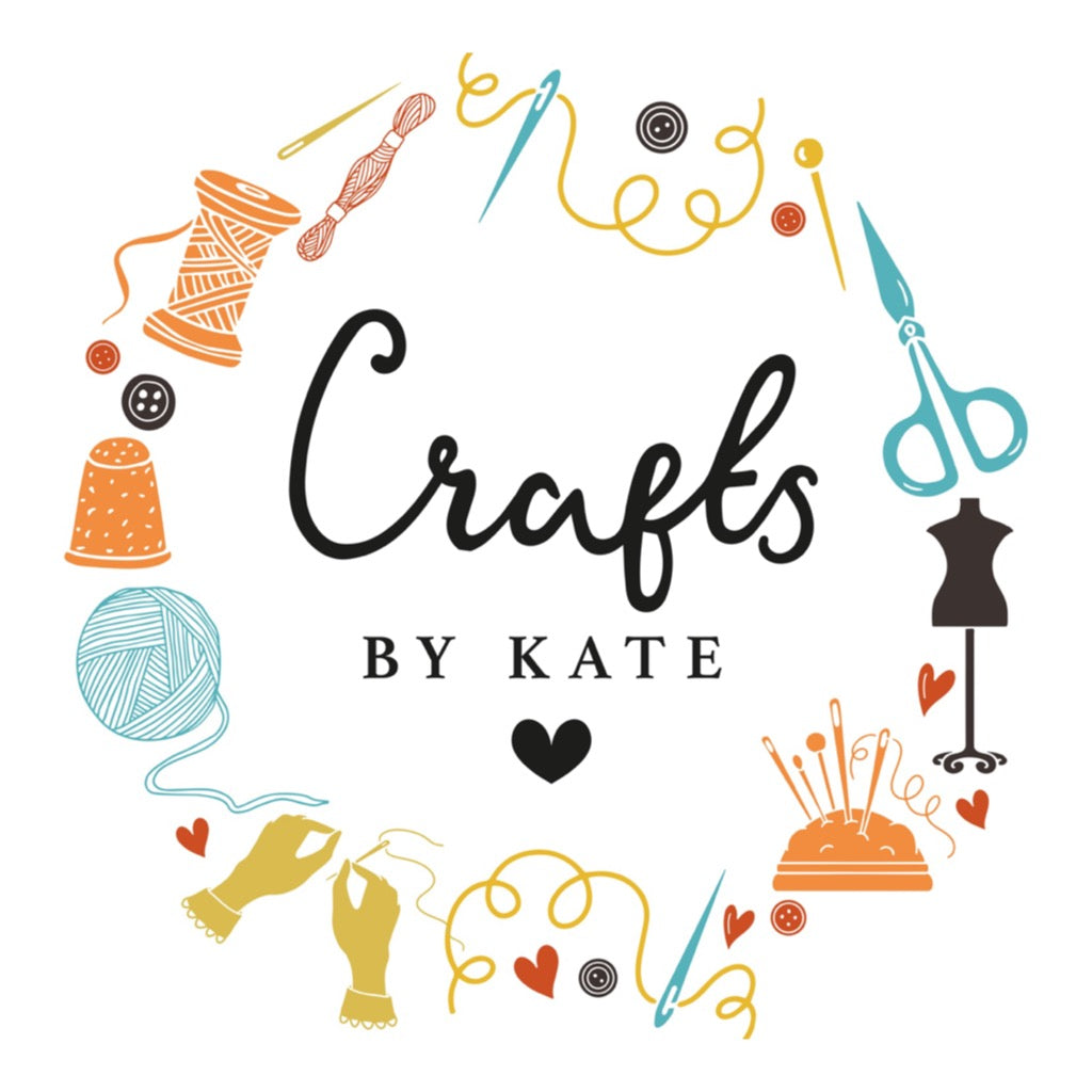 Circular logo with "Crafts by Kate," surrounded by sewing tools, yarn, scissors, a thimble, mannequin, and hands customizing a Personalised Ball is Life Box design, with a small heart underneath.